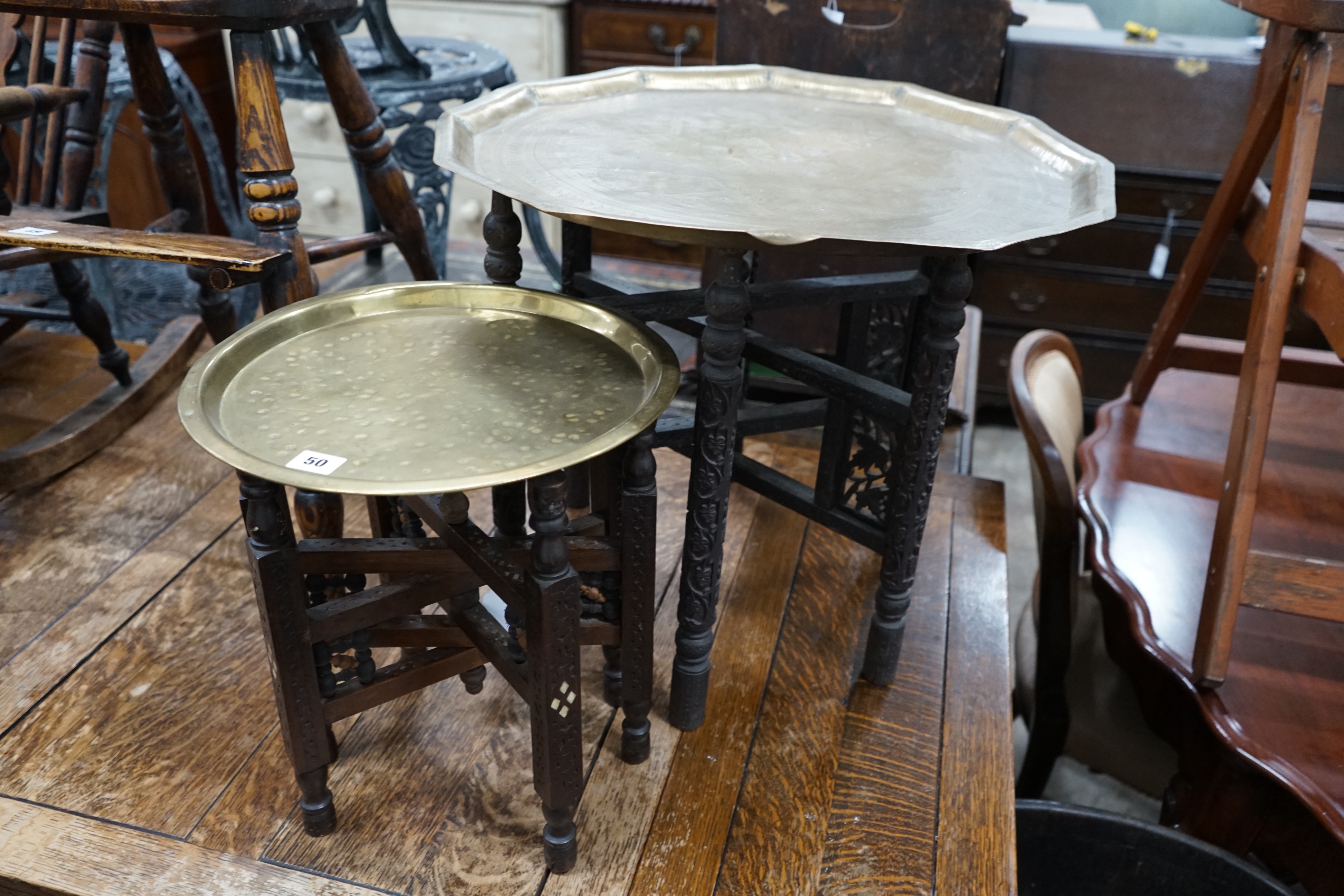 Two Indian brass tray top folding tables, largest width 56cm height 49cm